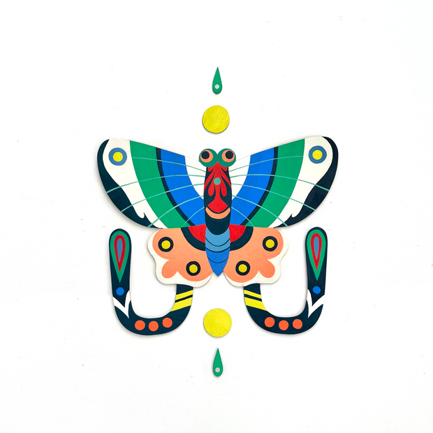 Die cut, brightly painted wooden sculpture of a kite butterfly, with blue, white and green striped top wings. Its bottom wings are peach colored with yellow dots and have 2 tails coming out, with colorful patterning. Atop and below are a small yellow sun and green water droplet.