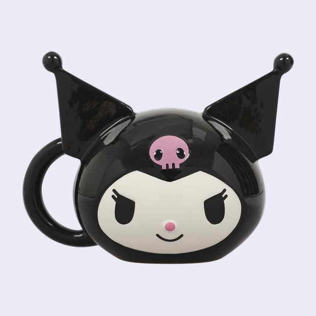 Ceramic mug of Kuromi's head, with her pointed ears sculpted off of the mug. A handle comes off the side of her head.