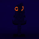 Sculpture of a stylized paddle or sword, modeled to look like Hedorah ink dark gray, orange and red colorings.l