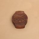 Die cut wooden box, shaped like a lantern with a partially opened eye and mouth with fangs.