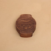 Die cut wooden box, shaped like a lantern with a partially opened eye and mouth with fangs.