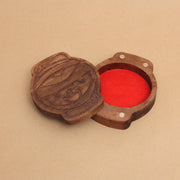 Die cut wooden box, shaped like a lantern with a partially opened eye and mouth with fangs. Lid slides off to reveal red felt inner lining 