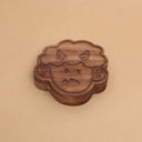 Die cut wooden box of a small, cute child's head with 2 horns and a tiny fang.
