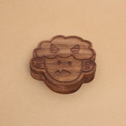 Die cut wooden box of a small, cute child's head with 2 horns and a tiny fang.