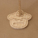 Close up of a wooden base shaped like a cartoon demon head, with a cute open mouth expression