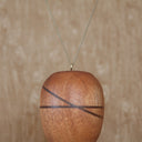 Wooden sculpture of a hot air ballon with a small bear sitting in the basket. 