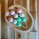 Wooden bowl with 3 sticks of Dango, a popular Japanese dessert comprising of 3 mochi balls (pink, white and green) on each stick.
