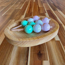 Wooden bowl with 3 sticks of Dango, a popular Japanese dessert comprising of 3 mochi balls (pink, white and green) on each stick.