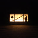 Shadow boxed type piece, a Shoji screen. When the light is turned on there is a silhouette of a Rokurokubi, aka Snake Neck Woman holding a hand fan. Can be hung by the sawtooth bracket or can sit on a flat surface.