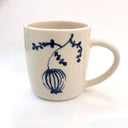 White mug with blue floral design on a white background