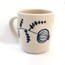 White mug with blue floral design on a white background