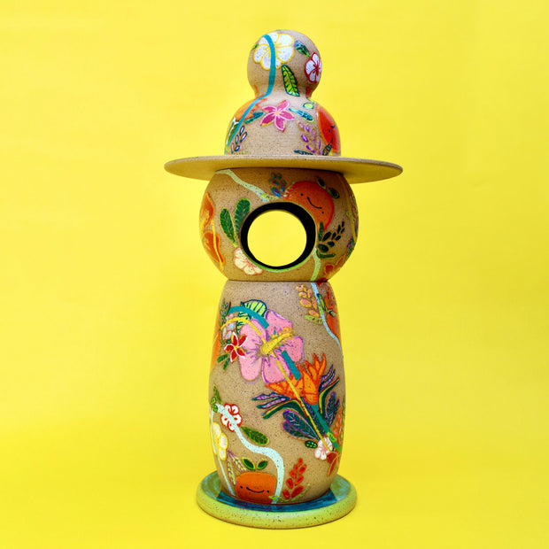 Sculptural piece comprising of 5 different ceramic parts to create a Japanese style lantern. The whole lantern is painted with themes of bright fruits and florals.