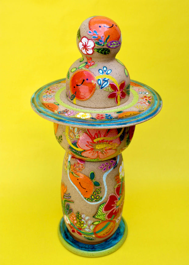 Sculptural piece comprising of 5 different ceramic parts to create a Japanese style lantern. The whole lantern is painted with themes of bright fruits and florals.