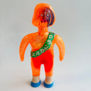 Vintage orange figure with a green sash on a light gray background