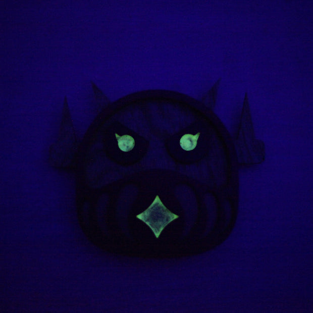 Glowing green face on a dark blue background