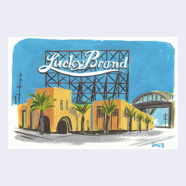 Plein air painting of a yellow building with palm trees in front of it. A large vintage sign reading "Lucky Brand" is behind on a wire backing.