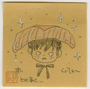 A square tan paper artwork featuring a cute illustrated face with a large sushi piece on its head, small stars, and handwritten text in black with a red stamp.