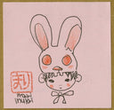 A hand-drawn illustration on a light pink square, showing a stylized rabbit head with long ears and a child-like face peeking out from behind, with a red stamp and the handwritten name 'mari inukai' in the lower left.