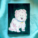 A painting of a fluffy white dog with pink shading on a dark green background, displayed on a light blue satin fabric backdrop.
