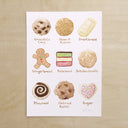 Illustration of 9 different types of cookies, with written labels below each.
