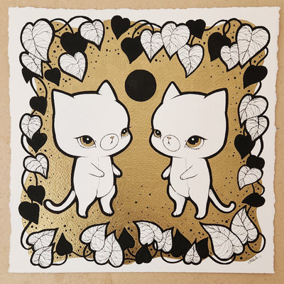 Black ink illustration on white paper with a gold leaf background of 2 cats standing and facing one another, with a black moon hanging in between them. They are framed by a vine of leaves.