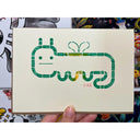 Block print of a worm character with a cartoon face and tiny wings.