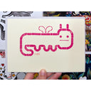 Block print of a worm character with a cartoon face and tiny wings.