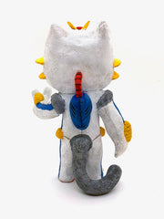 Sculpture of an orange cartoon tabby cat, dressed as a Evangelion style mech, in a white spacesuit with red, yellow and blue accessories. Its hand is extended out, fingers spread.