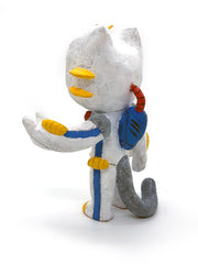 Sculpture of an orange cartoon tabby cat, dressed as a Evangelion style mech, in a white spacesuit with red, yellow and blue accessories. Its hand is extended out, fingers spread.