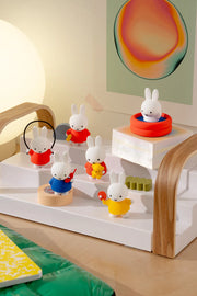 6 different Miffy figures, all doing various activities such as jump roping, swimming, playing table tennis, talking on the phone and holding plushies.