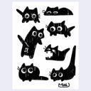 Black ink doodles on white paper of cartoon cats with large eyes.