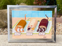 Illustration of three rolled cakes with different flavors on a checkered surface each with a cat head and tail, framed in silver.