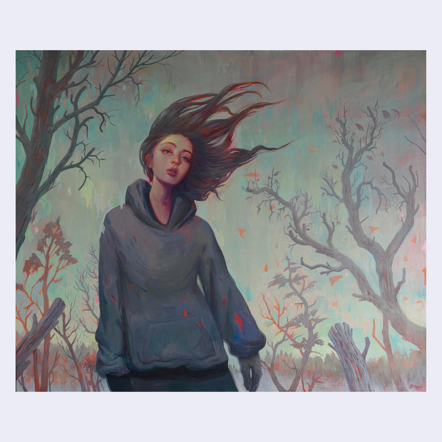 Painting in muted tones of a girl wearing a bluish gray hoodie. Her hair blows in the wind. Background is of barren trees.