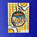 Artwork featuring a whimsical hand-drawn illustration of eggs in a coffee cup, with smiling faces and plaid accents, displayed on a textured blue background.