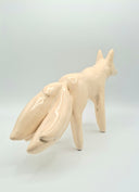 Ceramic fox figurine on a light gray background