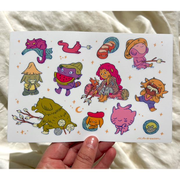 Sticker sheet containing 12 stickers of cute cartoon fantasy creatures, doing various activities as though they are camping outdoors.