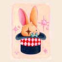 A pastel illustration of a small orange bunny with long pink-tinted ears sitting inside a magician's hat. The hat has a red-and-white diamond pattern and a dark navy base.