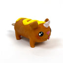 Sculpture of a corn dog, designed to look like a dog with a cute, silly face and a metallic unicorn horn atop its head. It has a squiggle of mustard on its back.