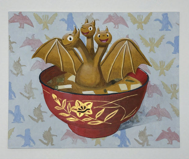 Painting of a cartoon style Ghidorah, golden and spreading its wings in a bowl of miso soup. The background is a repeating pattern of various kaiju monster silhouettes. Shown at an angle to display gold bowl detailing.
