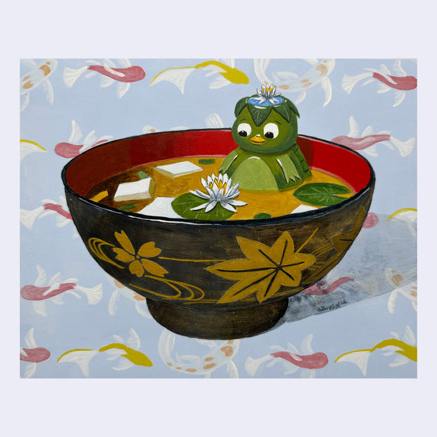 Painting of a small kappa, a green turtle like figure, sitting inside of a bowl of miso soup with cubes of tofu and small lily pads and a white flower. Background is a painted koi fish pattern.