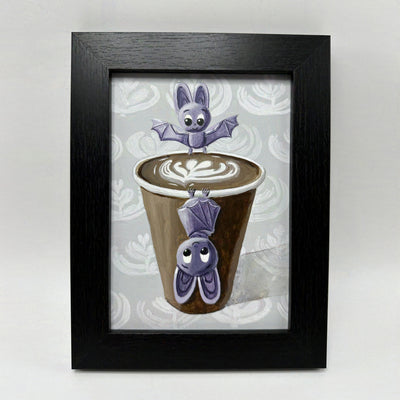 Painting of 2 cartoon style purple bats, positioned around a brown to go coffee cup with latte art. One bat stands on the cup lip and the other hangs upside down off the front.