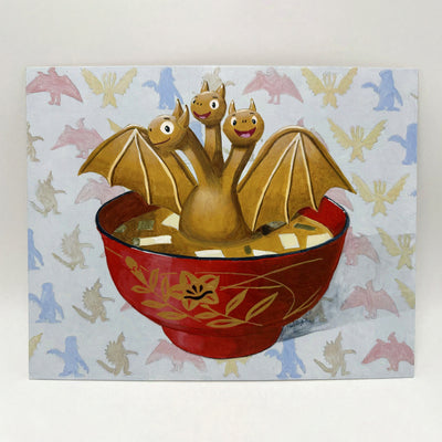 Painting of a cartoon style Ghidorah, golden and spreading its wings in a bowl of miso soup. The background is a repeating pattern of various kaiju monster silhouettes. 