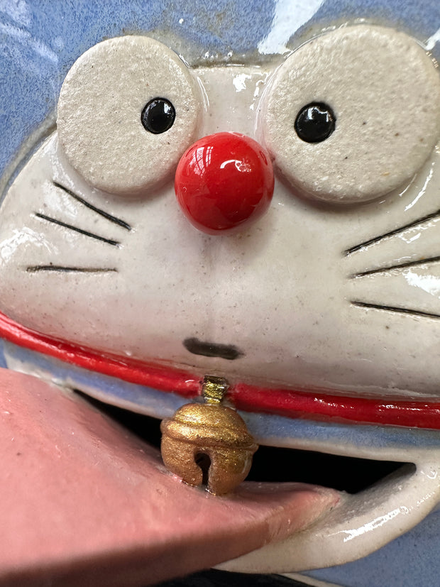 Close up of ceramic Doraemon's face.
