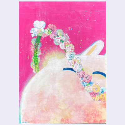 Painting on bright pink panel of a rabbit's head with a rising sun behind it and a flower crown orbiting around it.