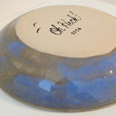 Ceramic plate with blue glaze and 'Oh Heck!' text on a beige backing.