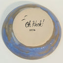 Ceramic plate with blue glaze and 'Oh Heck!' text on a beige backing.