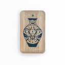 Wooden tray with a blue line art painting on it of a vase with an orchid floral design on the front. Floating over a vase is a star.