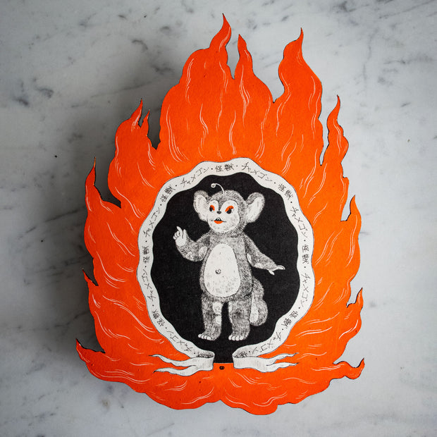 Illustrative painting of Chamegon, a cute mouse monster on a black background surrounded by a scroll with written script and cut out bright orange flames.