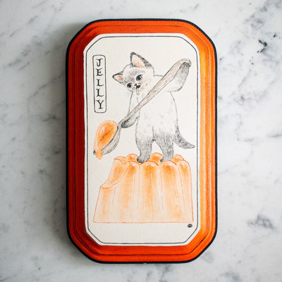 Black ink illustration on white paper of a cat standing and holding a large wooden spoon, scooping a molded orange jelly. Piece is mounted on an orange wooden plaque.
