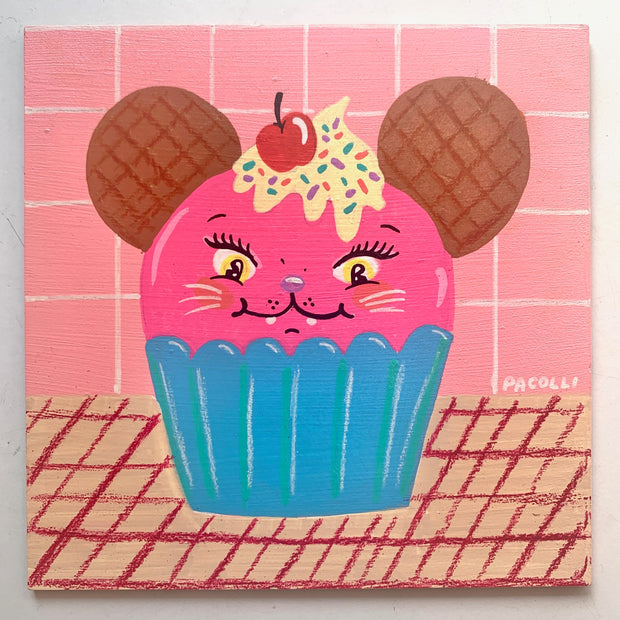 Painting of a bright pink cupcake in a blue liner. Cupcake has a face of a cat with makeup, and smiles. Atop its head is dripping cream with sprinkles and a cherry and it has 2 round waffle cookie ears.